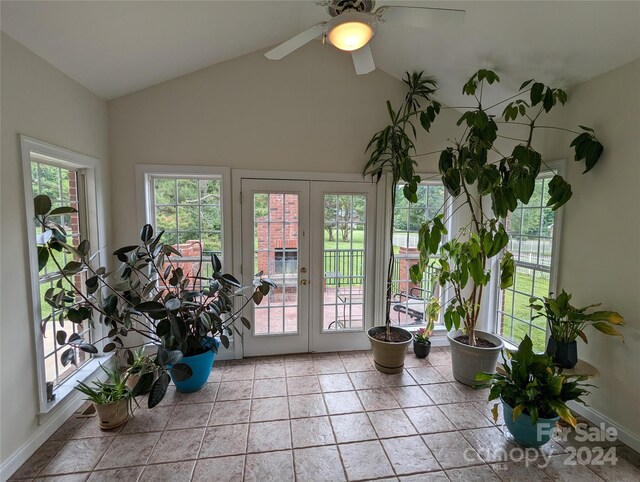 sunroom / solarium featuring vaulted ceiling, ceiling fan, and french doors