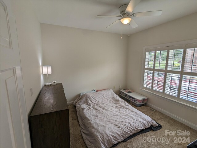 carpeted bedroom with ceiling fan