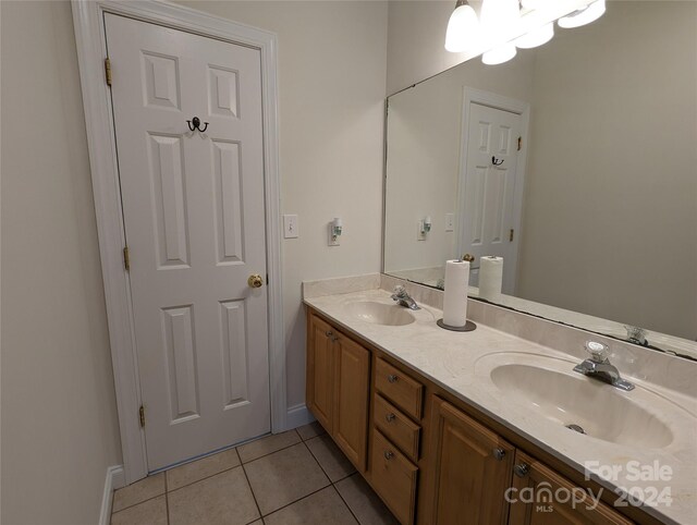 bathroom featuring dual vanity and tile floors