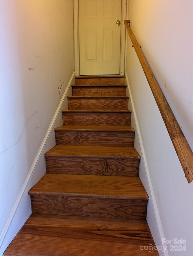 stairway featuring hardwood / wood-style flooring