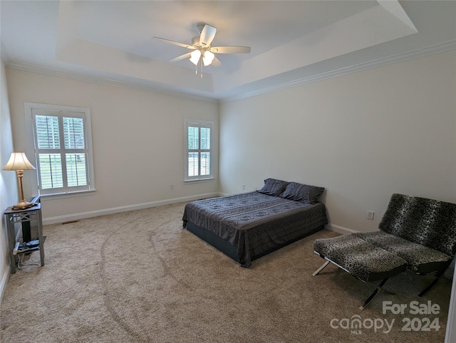 bedroom featuring carpet, ceiling fan, a raised ceiling, and crown molding