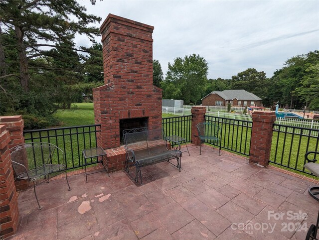 view of patio featuring an outdoor brick fireplace