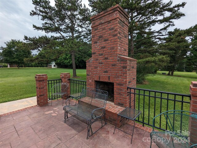 view of terrace with a storage shed and an outdoor brick fireplace