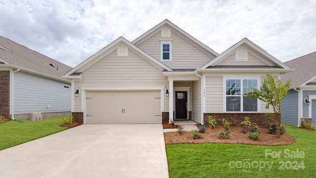 craftsman-style house with a garage and a front yard