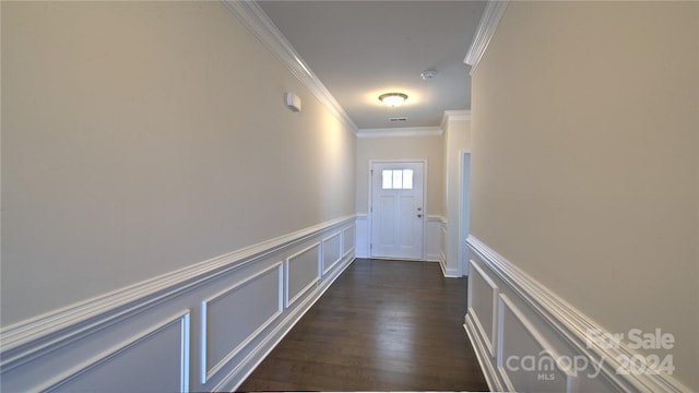 hallway with dark hardwood / wood-style flooring and crown molding