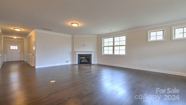 unfurnished living room with dark hardwood / wood-style flooring and ornamental molding