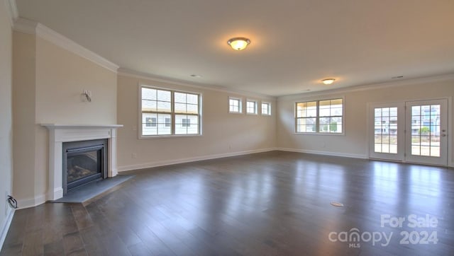 unfurnished living room featuring ornamental molding and dark hardwood / wood-style flooring