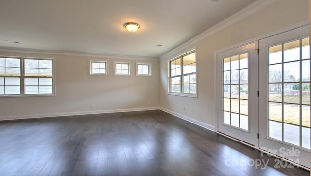 unfurnished room featuring a wealth of natural light, dark wood-type flooring, and crown molding