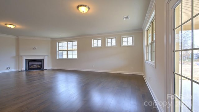 unfurnished living room featuring ornamental molding and dark wood-type flooring