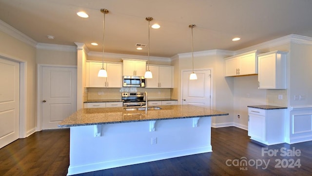 kitchen with dark hardwood / wood-style flooring, stainless steel appliances, dark stone counters, pendant lighting, and tasteful backsplash