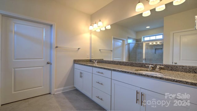 bathroom featuring double vanity and tile flooring