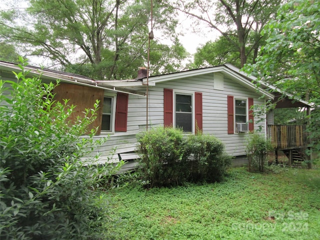 view of side of home featuring a yard