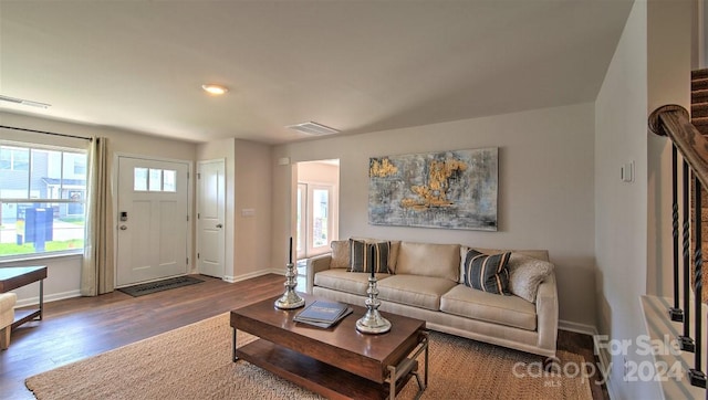 living room featuring dark wood-type flooring