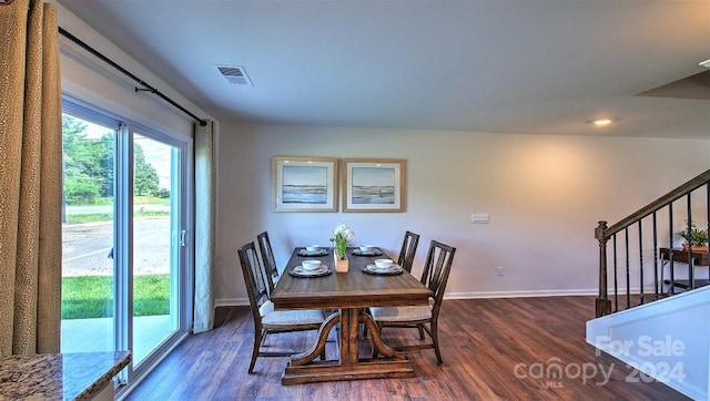 dining space with dark hardwood / wood-style flooring