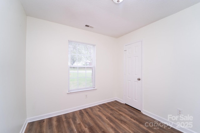 empty room featuring dark wood-type flooring