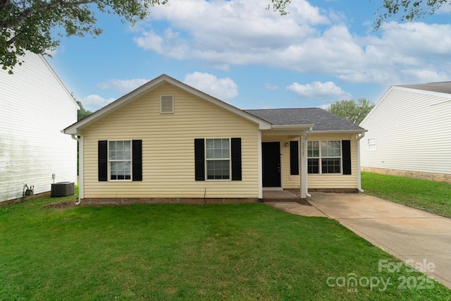 ranch-style home with a front lawn and central air condition unit