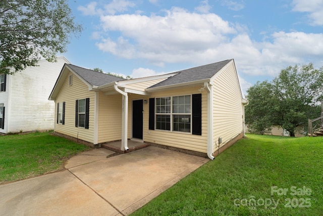 ranch-style house with a front lawn and a patio