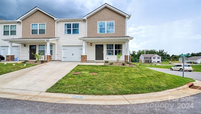 view of property featuring a garage and a front yard