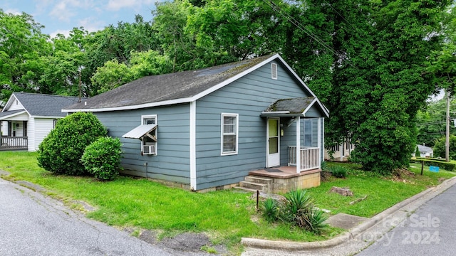 bungalow-style house with a front lawn