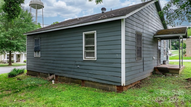 view of side of property with a yard