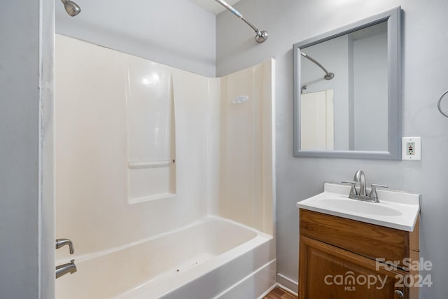 bathroom featuring  shower combination and vanity