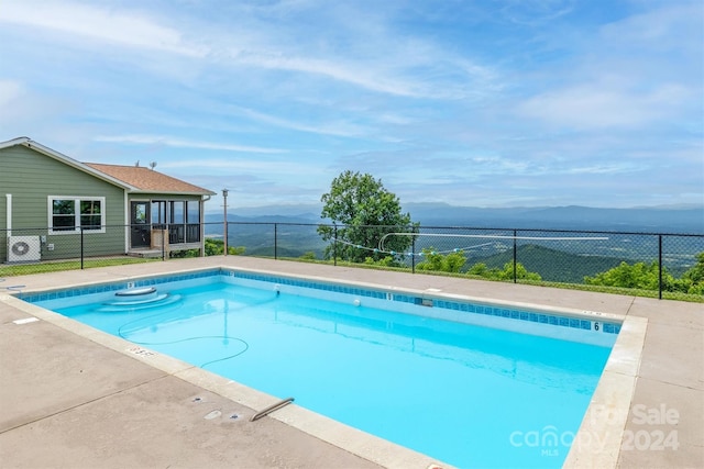 view of swimming pool featuring a mountain view