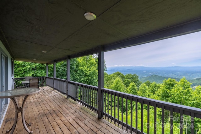 wooden deck with a mountain view