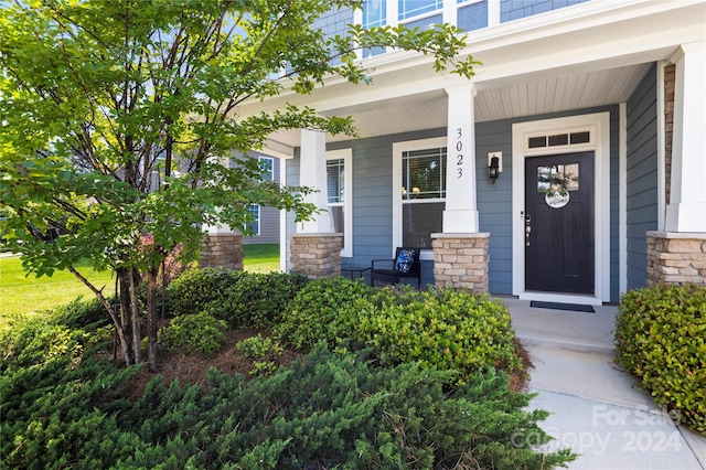 view of exterior entry with a porch