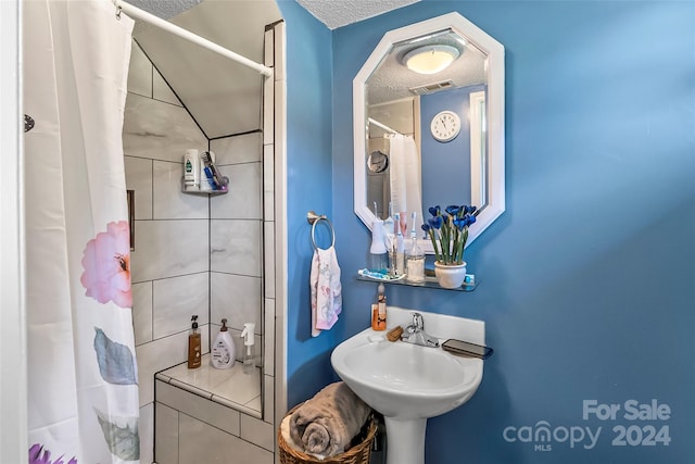 bathroom with sink and a textured ceiling