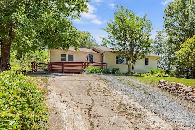 ranch-style house featuring a wooden deck