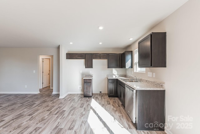 kitchen with dark brown cabinets, dishwasher, sink, and light hardwood / wood-style flooring