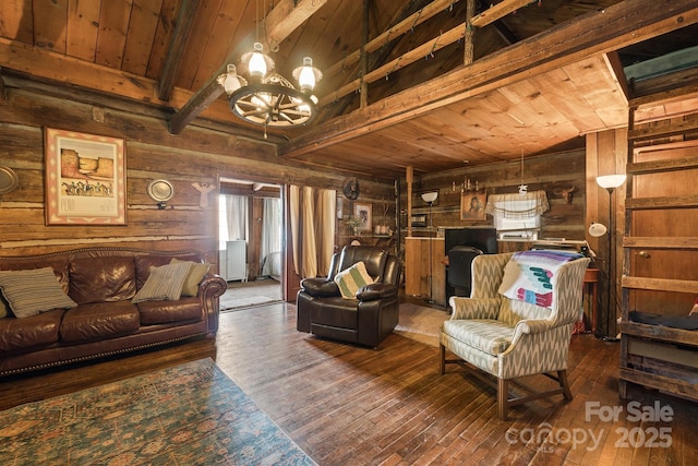 living room with wooden walls, beamed ceiling, wood ceiling, and wood-type flooring