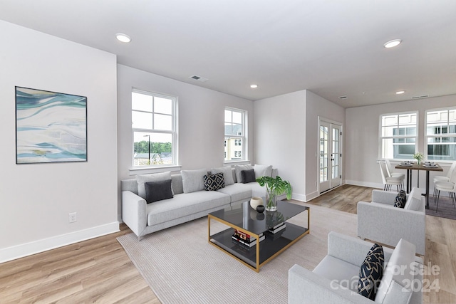 living room with light hardwood / wood-style floors and french doors