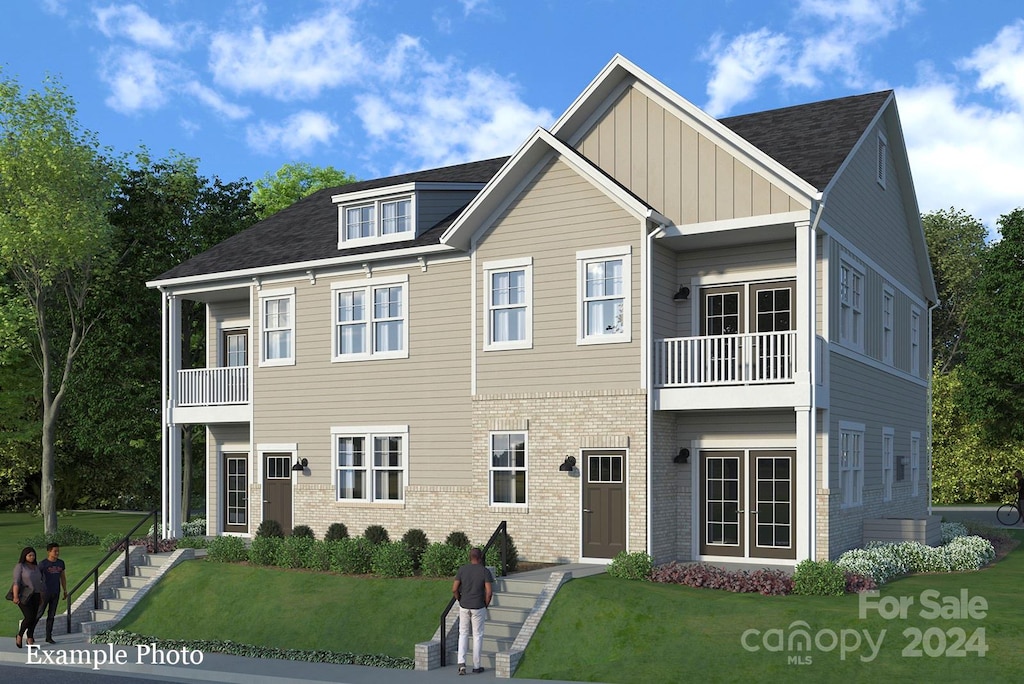 view of front of property with a front yard and a balcony