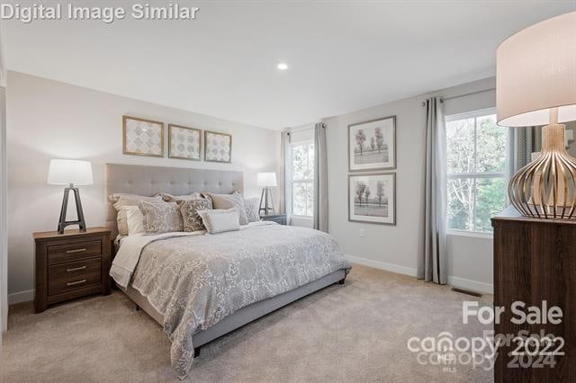 bedroom featuring light colored carpet