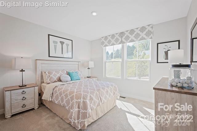 bedroom featuring light colored carpet