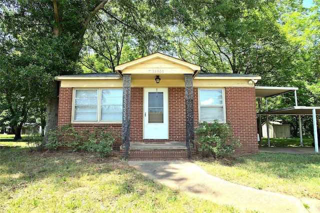 bungalow featuring a front yard and a carport