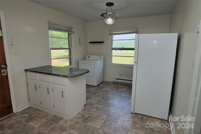 kitchen featuring white cabinets, white refrigerator, a baseboard radiator, plenty of natural light, and washer / dryer