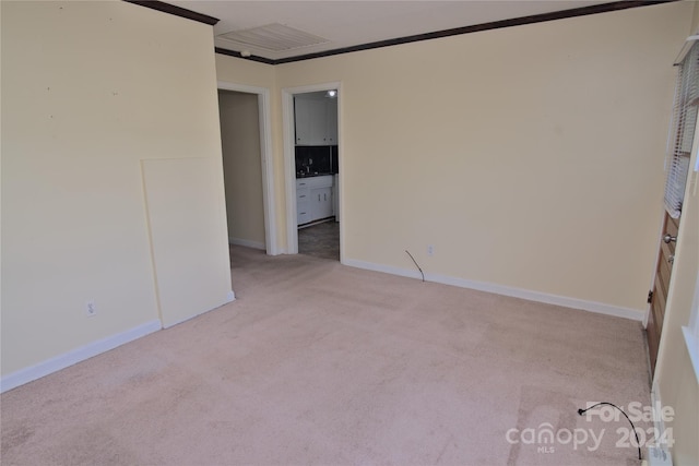 carpeted empty room featuring ornamental molding