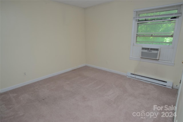 unfurnished room with cooling unit, light colored carpet, and a baseboard heating unit