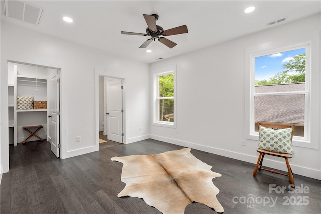 sitting room featuring ceiling fan and dark wood-type flooring