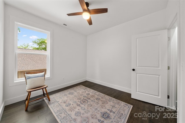 sitting room with ceiling fan and dark hardwood / wood-style floors