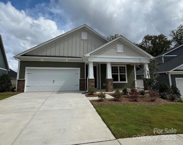 craftsman house with covered porch and a garage