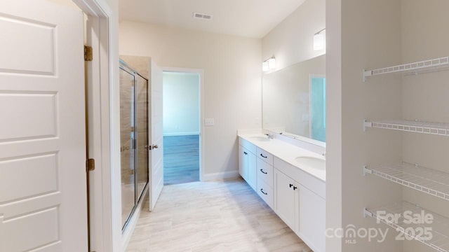 bathroom featuring vanity and an enclosed shower