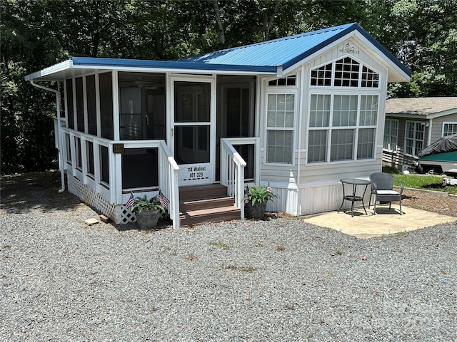 view of front of house with a sunroom