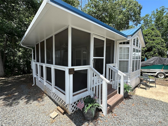 view of home's exterior with a sunroom