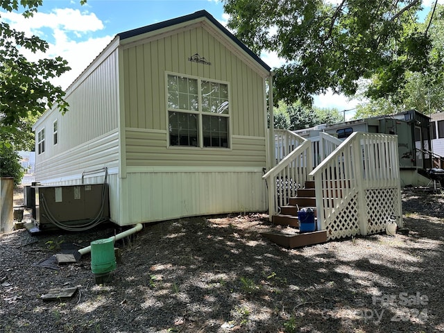 back of house featuring a wooden deck