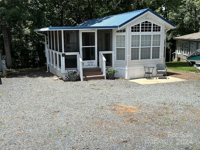 view of front of home with a sunroom