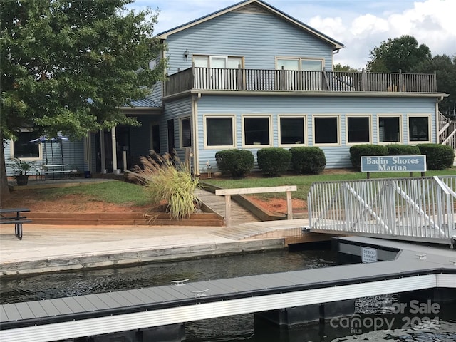 rear view of property with a wooden deck and a balcony