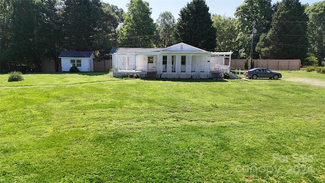 exterior space featuring covered porch and a storage shed